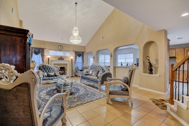 living room with visible vents, baseboards, stairs, light tile patterned floors, and a fireplace