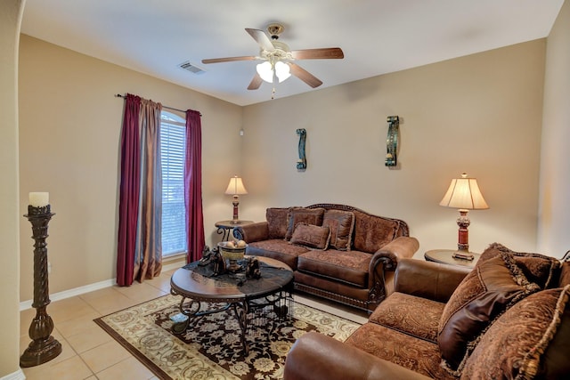 living room featuring light tile patterned flooring, baseboards, visible vents, and ceiling fan