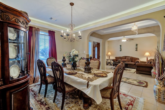 dining room featuring visible vents, light tile patterned flooring, arched walkways, ornamental molding, and ceiling fan with notable chandelier