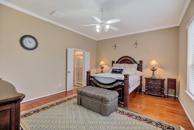 bedroom with visible vents, crown molding, baseboards, light wood-type flooring, and ensuite bathroom