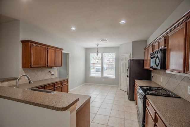 kitchen with light tile patterned flooring, a sink, electric range oven, black microwave, and brown cabinets