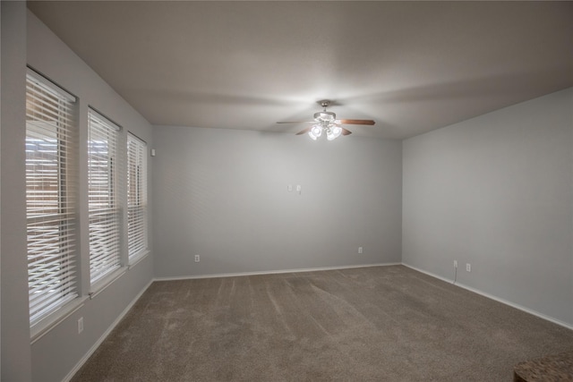 empty room featuring ceiling fan, baseboards, and carpet floors