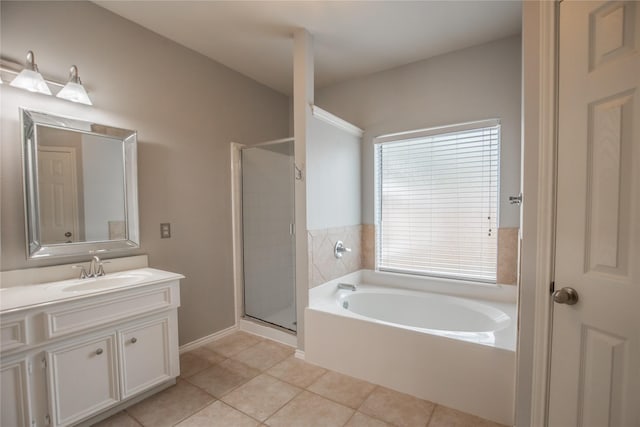 full bathroom featuring vanity, tile patterned floors, a bath, and a stall shower