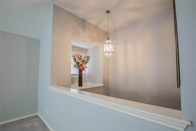 hallway featuring baseboards and carpet floors