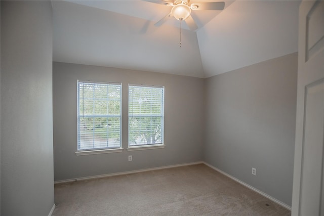 unfurnished room featuring lofted ceiling, baseboards, and carpet floors