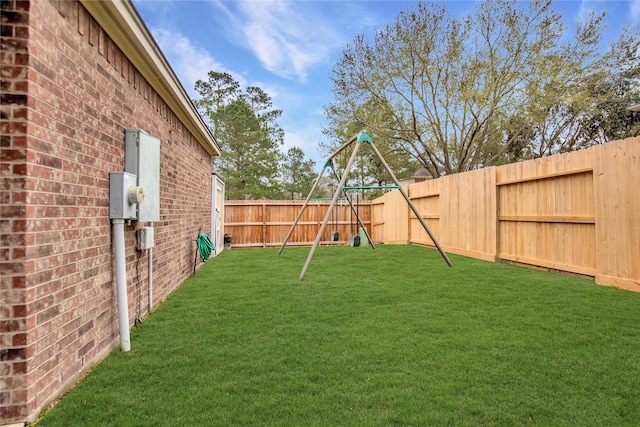 view of yard featuring a fenced backyard and a playground