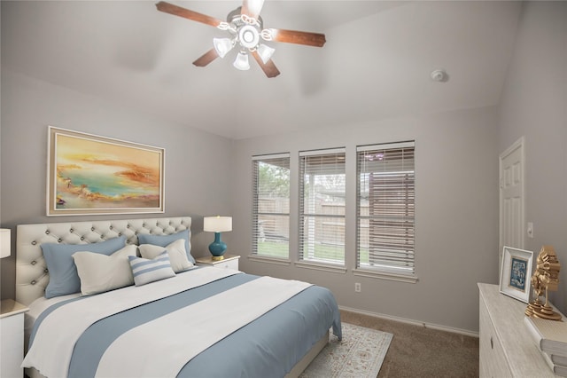 carpeted bedroom with baseboards, a ceiling fan, and vaulted ceiling