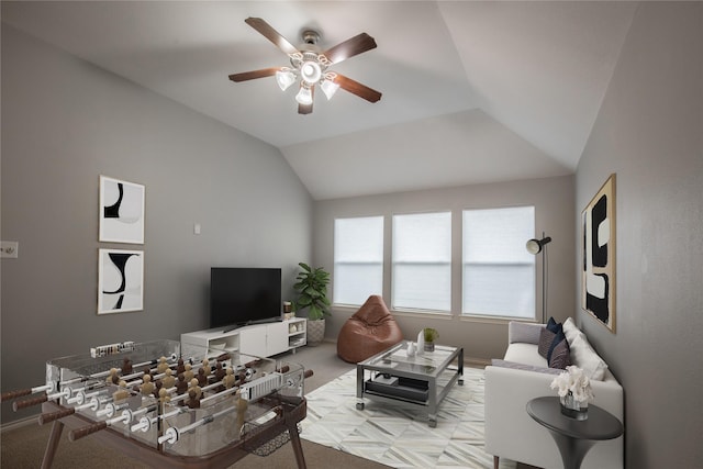 living area featuring carpet flooring, ceiling fan, baseboards, and lofted ceiling