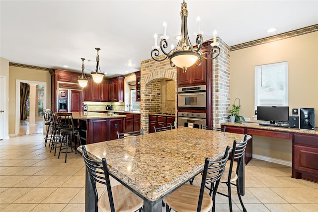 kitchen with stainless steel double oven, a kitchen bar, light tile patterned flooring, and a center island