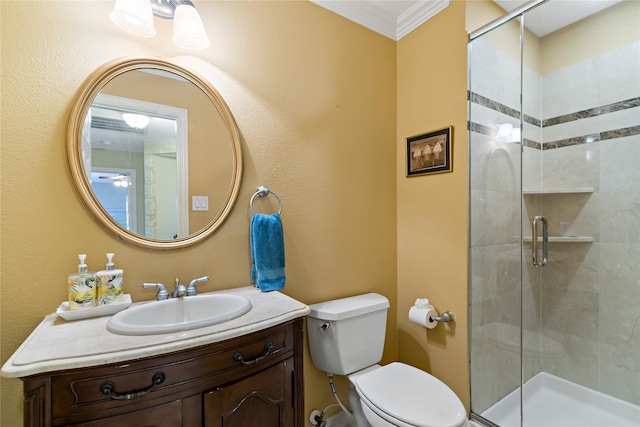 bathroom with toilet, a stall shower, vanity, and crown molding