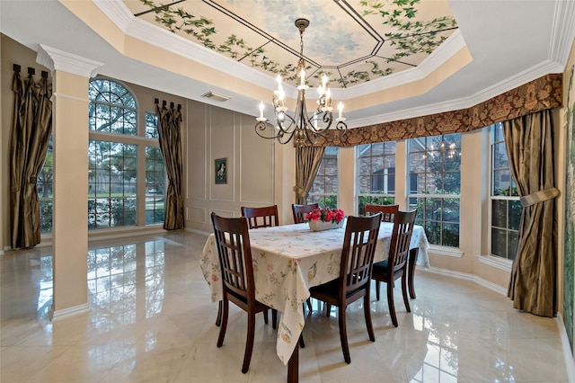 dining room with visible vents, an inviting chandelier, crown molding, a raised ceiling, and a decorative wall