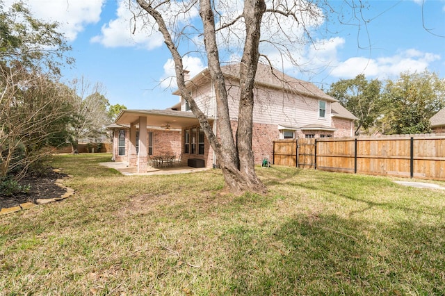 view of yard featuring a ceiling fan, a patio area, and fence