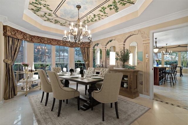 dining area featuring an inviting chandelier, light tile patterned floors, crown molding, and a tray ceiling