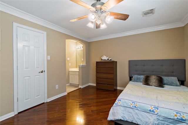 bedroom featuring arched walkways, visible vents, baseboards, and wood finished floors