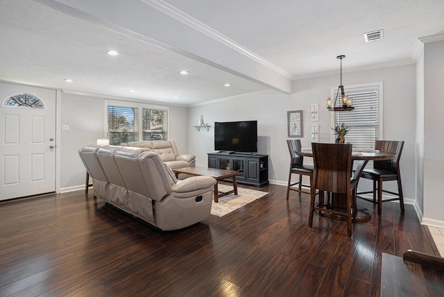 living area with visible vents, baseboards, dark wood-style flooring, and ornamental molding