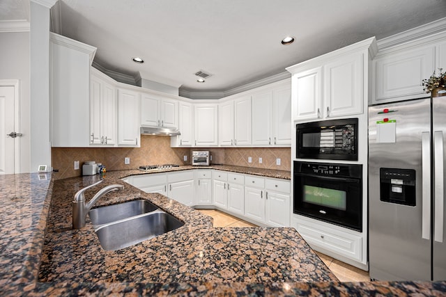 kitchen with visible vents, under cabinet range hood, light tile patterned floors, black appliances, and a sink