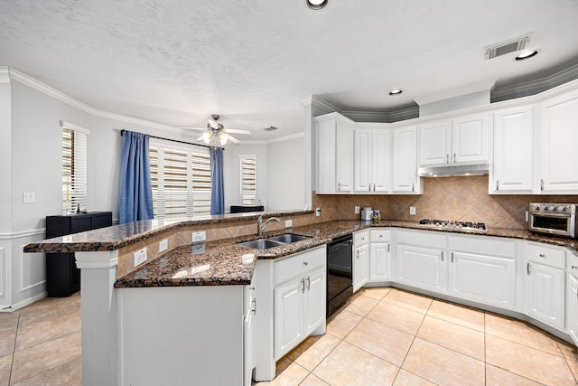 kitchen with visible vents, under cabinet range hood, a sink, a peninsula, and dishwasher