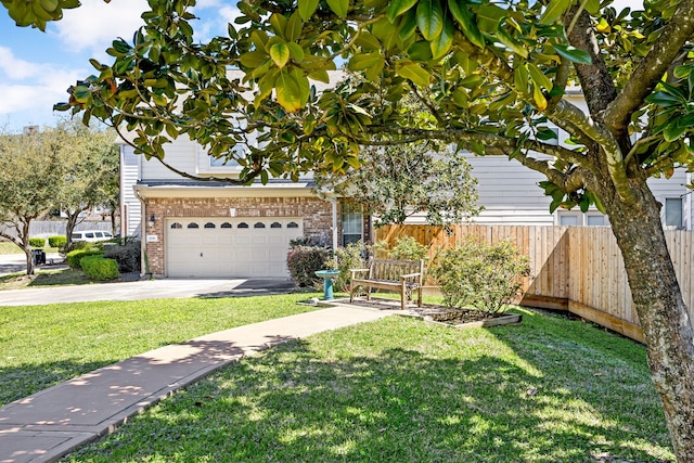 view of property hidden behind natural elements featuring brick siding, a front lawn, fence, a garage, and driveway