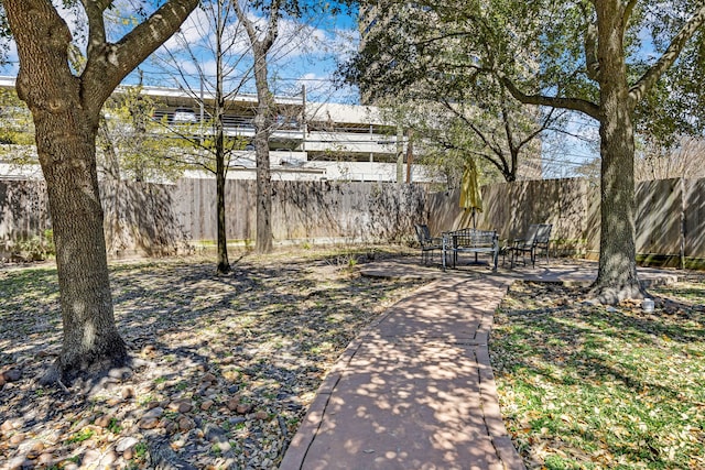 view of yard featuring a patio and fence