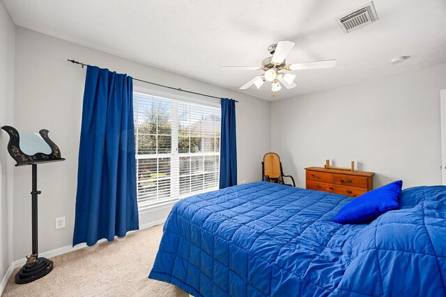 bedroom with visible vents, carpet floors, baseboards, and a ceiling fan