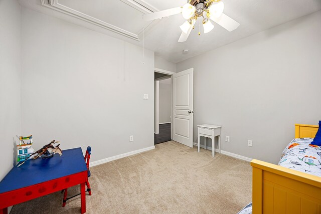 bedroom featuring baseboards, light colored carpet, attic access, and ceiling fan