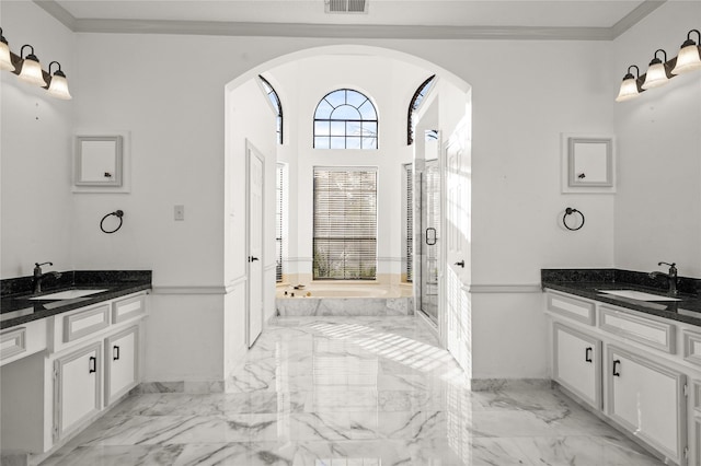 bathroom featuring crown molding, two vanities, marble finish floor, and a sink