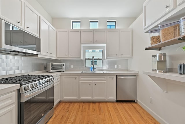 kitchen featuring light countertops, a toaster, appliances with stainless steel finishes, and a sink