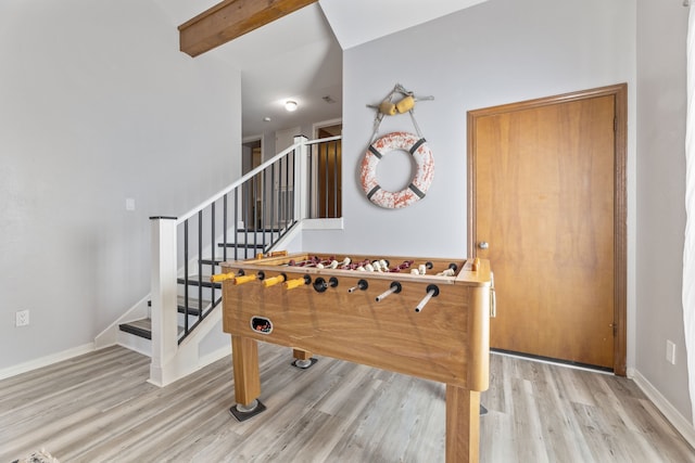 rec room with beamed ceiling, baseboards, and wood finished floors