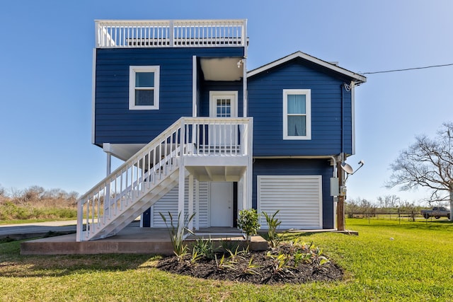 rear view of house with a yard and stairway