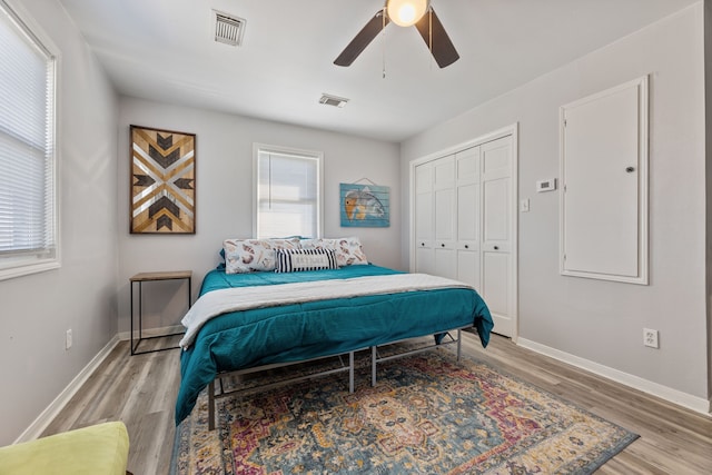 bedroom with light wood-style flooring, baseboards, and visible vents