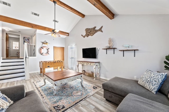 living area featuring visible vents, stairs, and wood finished floors