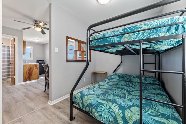 bedroom with light wood-style floors and baseboards