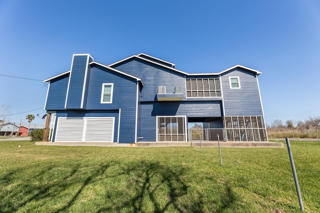 rear view of property with a yard, fence, and a sunroom