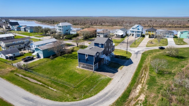 drone / aerial view with a residential view and a water view