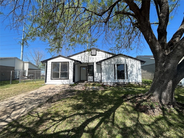 bungalow-style home with a front yard and fence