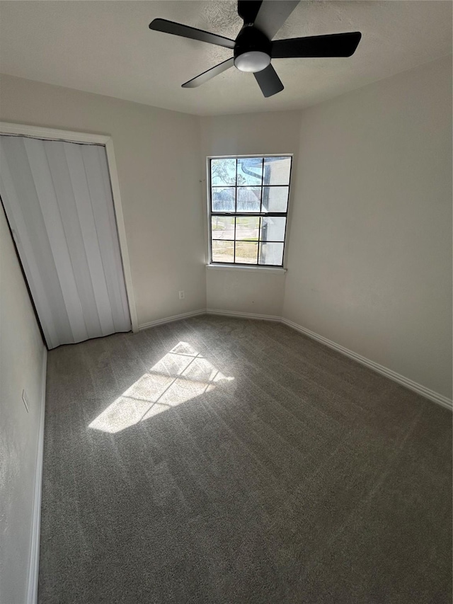 unfurnished bedroom featuring a closet, baseboards, and carpet