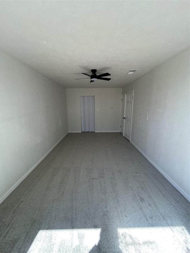 unfurnished living room with visible vents, baseboards, a ceiling fan, and carpet flooring