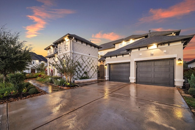 view of front of house featuring stucco siding, a garage, and driveway