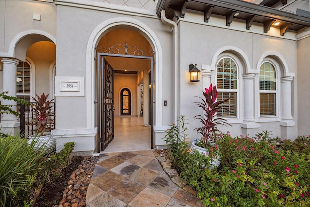 property entrance with stucco siding