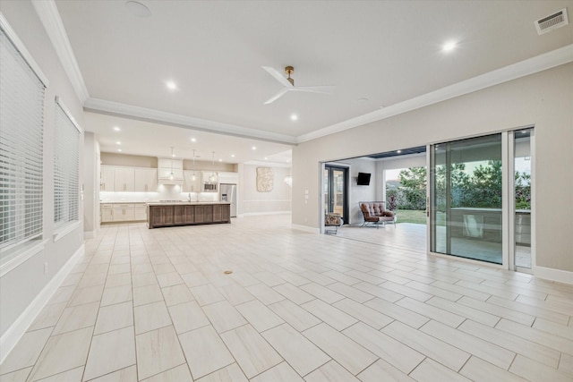 unfurnished living room with baseboards, visible vents, recessed lighting, ceiling fan, and crown molding