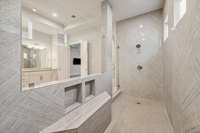 bathroom with vanity, visible vents, and a stall shower