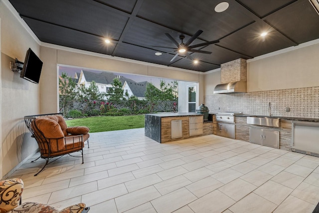 view of patio with fence, an outdoor kitchen, area for grilling, ceiling fan, and a sink