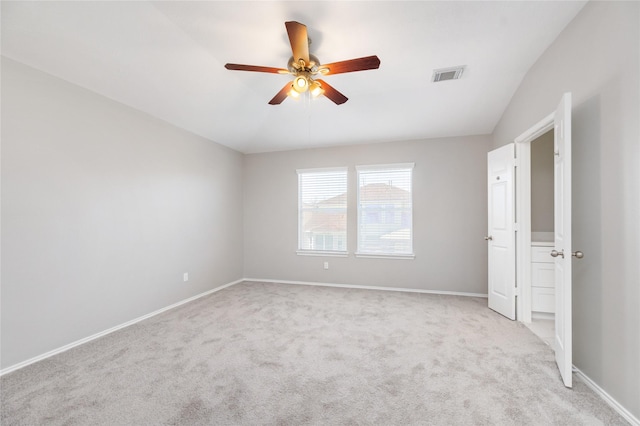 unfurnished room with a ceiling fan, baseboards, visible vents, lofted ceiling, and light carpet