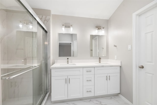 full bath with a sink, marble finish floor, and a shower stall