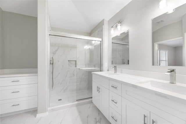 full bath with a sink, a marble finish shower, and marble finish floor