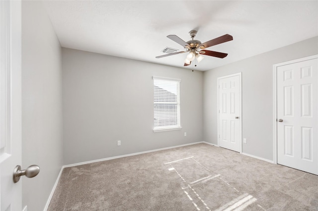 unfurnished bedroom with visible vents, baseboards, carpet, and ceiling fan