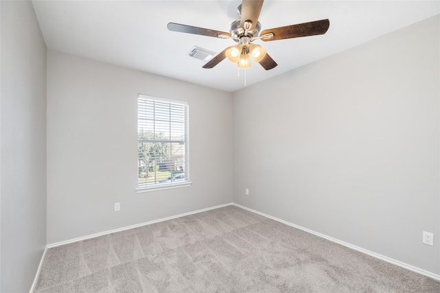 carpeted spare room featuring a ceiling fan, baseboards, and visible vents