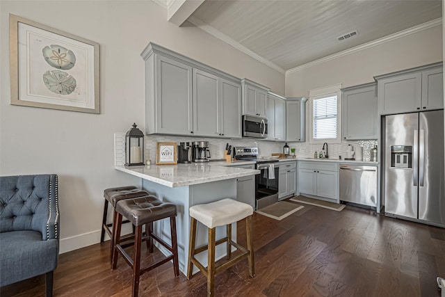 kitchen with a peninsula, visible vents, appliances with stainless steel finishes, and gray cabinetry