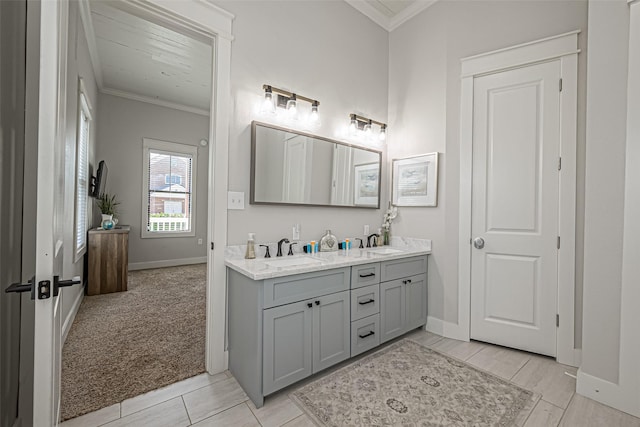 full bath featuring double vanity, ornamental molding, and a sink