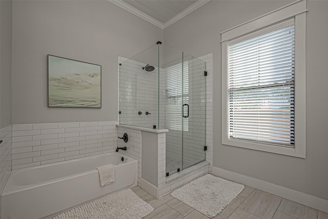 full bathroom with baseboards, a garden tub, a shower stall, and crown molding